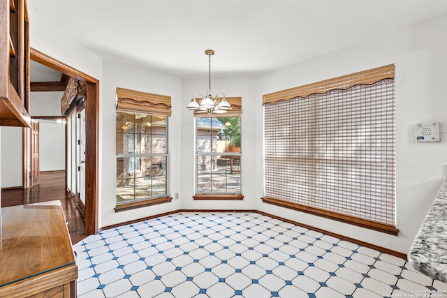 unfurnished dining area featuring a notable chandelier