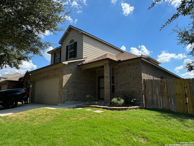 view of front of house featuring a front yard and a garage