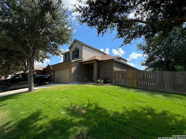 view of front of home featuring a garage and a front lawn