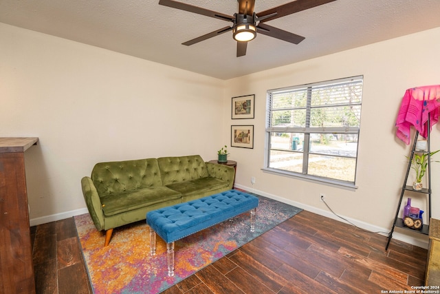 sitting room featuring ceiling fan, a textured ceiling, and dark wood-type flooring