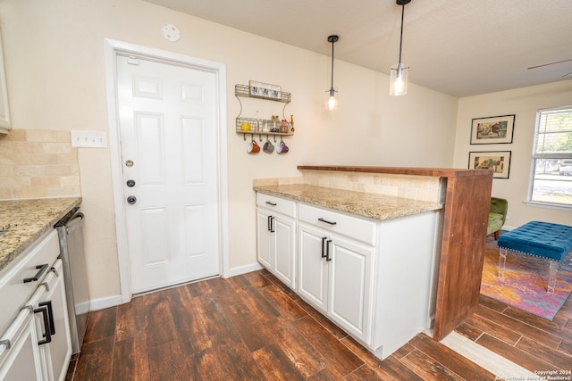 kitchen with white cabinets, decorative light fixtures, dark hardwood / wood-style flooring, and light stone countertops