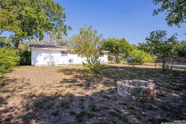 view of yard with an outdoor fire pit