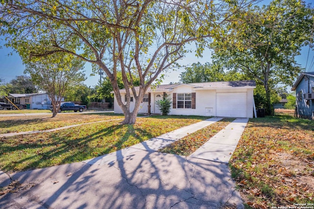 view of front of house with a front yard and a garage