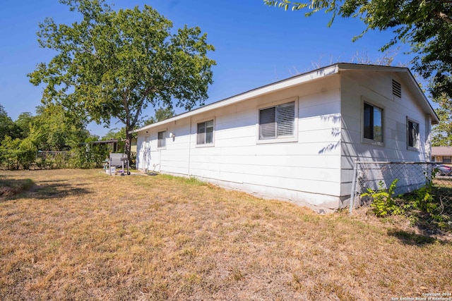 view of side of home featuring a yard