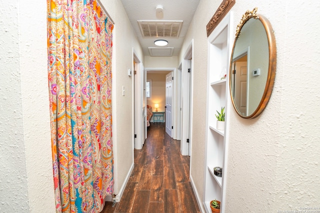 hallway with dark hardwood / wood-style flooring