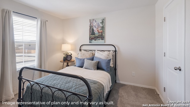 carpeted bedroom featuring baseboards
