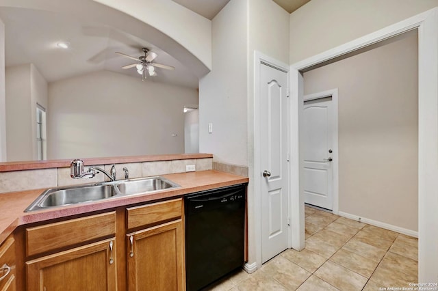 kitchen with lofted ceiling, ceiling fan, sink, light tile patterned flooring, and black dishwasher