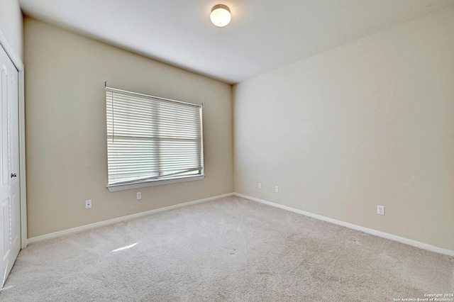 unfurnished room with light carpet