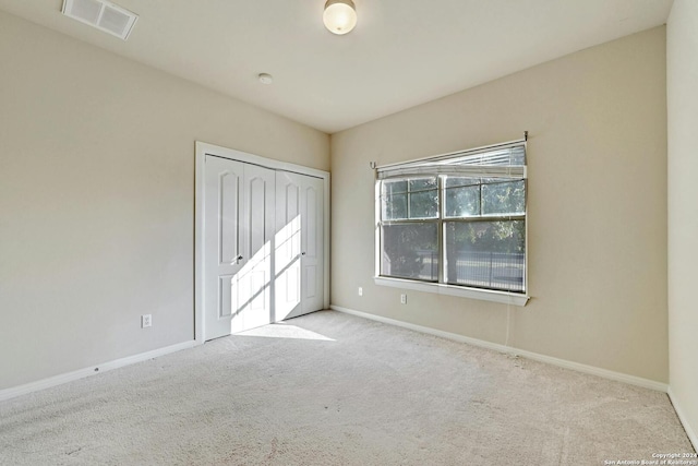 empty room featuring light colored carpet