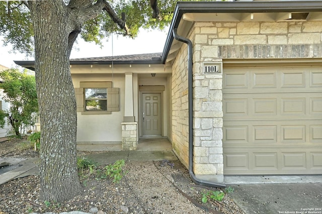 doorway to property featuring a garage