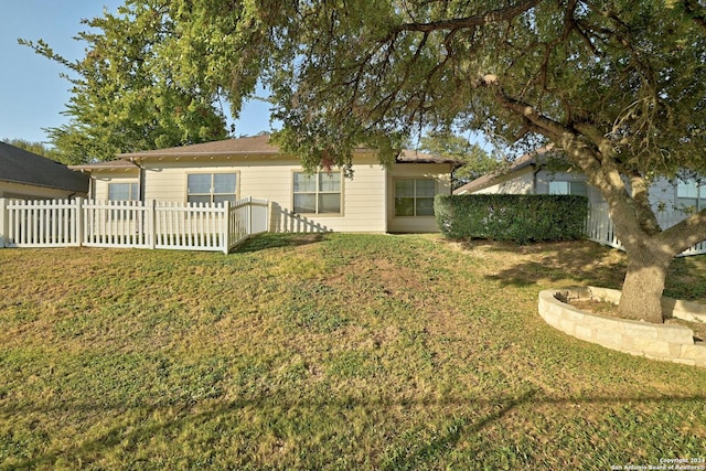 rear view of house featuring a lawn