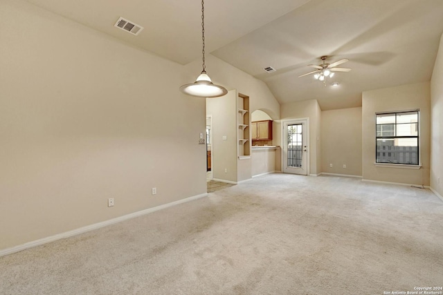 unfurnished living room featuring lofted ceiling, ceiling fan, and light carpet