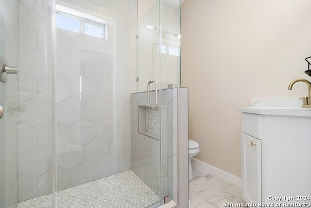 bathroom featuring vanity, toilet, and walk in shower