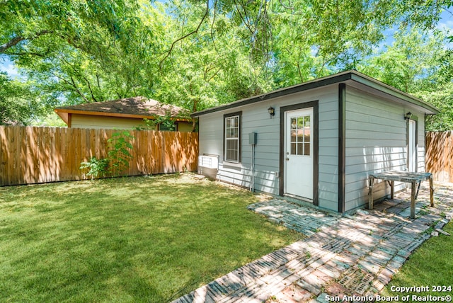 view of outdoor structure with a lawn