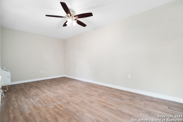 spare room featuring light wood-type flooring and ceiling fan