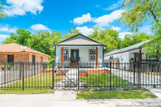 bungalow with a porch and a front lawn