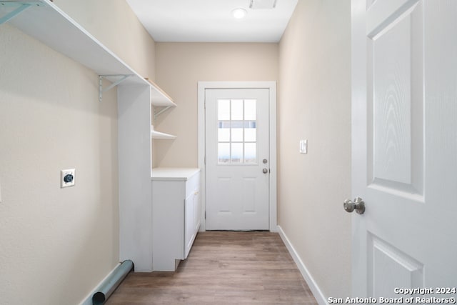 laundry room with light hardwood / wood-style flooring and hookup for an electric dryer