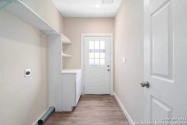 341 Lone Star, San Antonio, TX 78204 - washroom with light wood finished floors, baseboards, electric dryer hookup, and laundry area