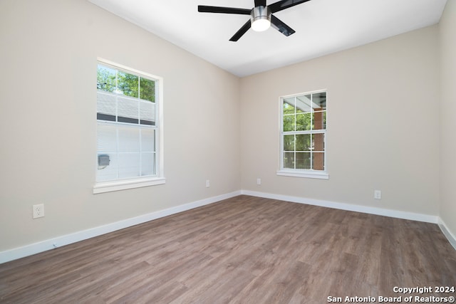 unfurnished room with ceiling fan and wood-type flooring