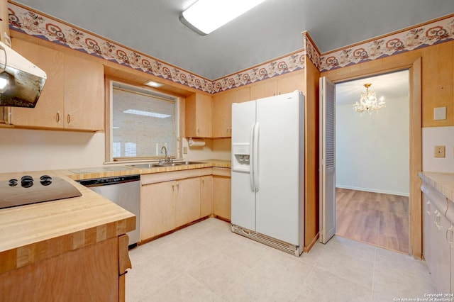 kitchen with light brown cabinets, white refrigerator with ice dispenser, sink, a notable chandelier, and dishwasher