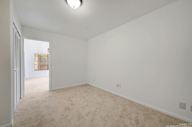 spare room with light colored carpet