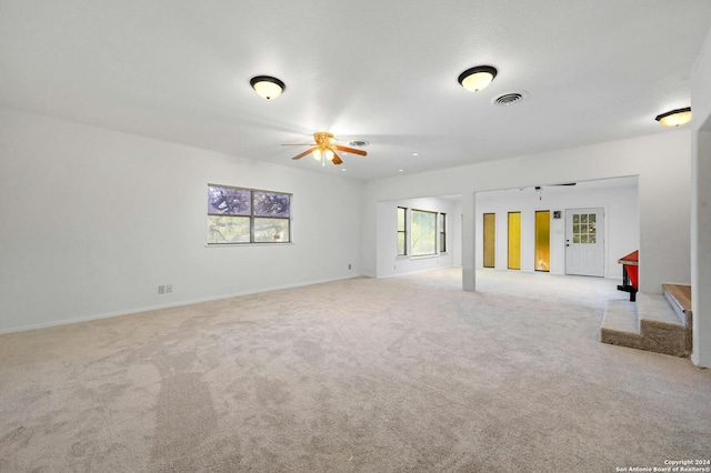 carpeted spare room with ceiling fan