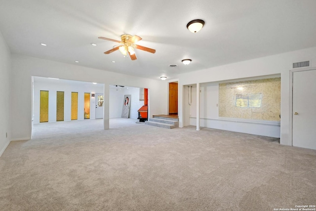 carpeted empty room featuring ceiling fan