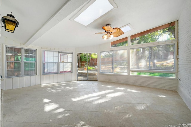 unfurnished sunroom with plenty of natural light, ceiling fan, and lofted ceiling with skylight