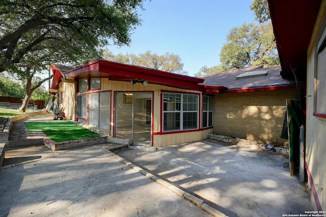 back of house with a patio