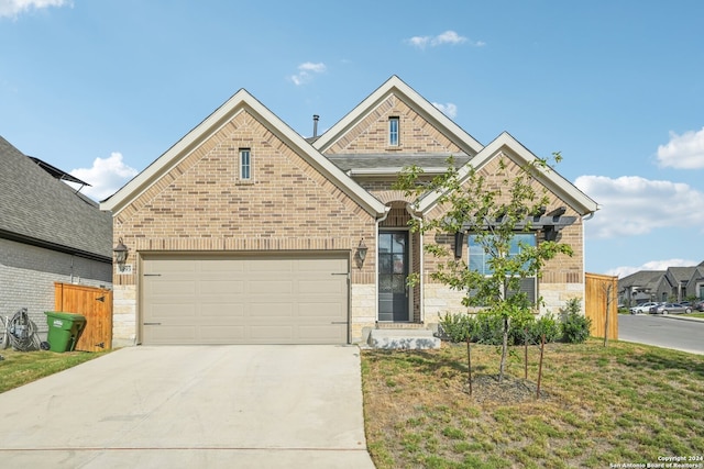 view of front of property featuring a garage and a front lawn