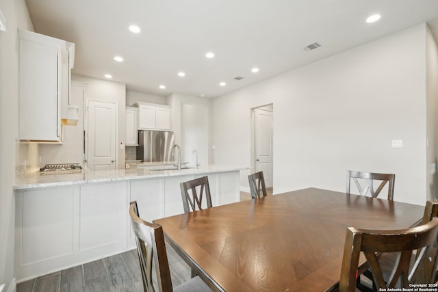 dining room featuring dark wood-type flooring and sink