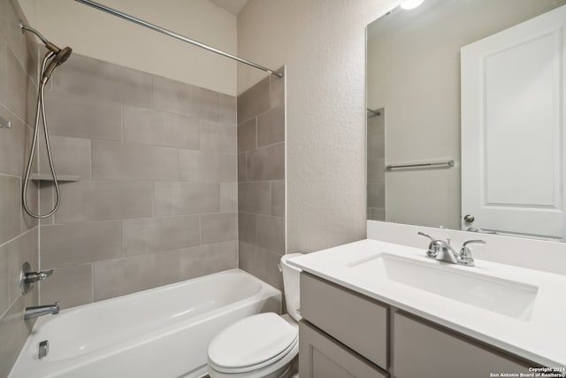 full bathroom with vanity, toilet, and tiled shower / bath combo