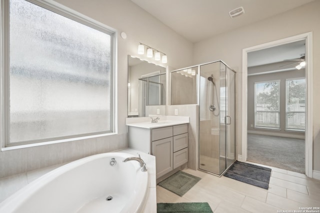 bathroom with ceiling fan, tile patterned flooring, separate shower and tub, and vanity