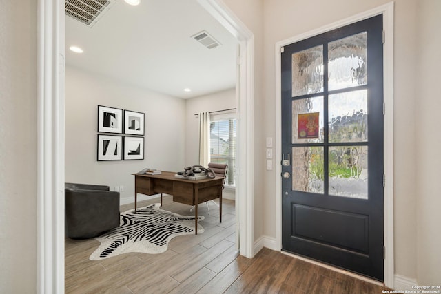 doorway to outside featuring hardwood / wood-style flooring and a wealth of natural light