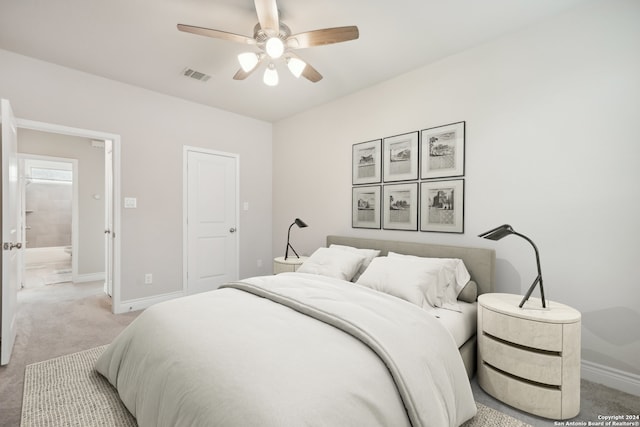 bedroom featuring ceiling fan, connected bathroom, and carpet