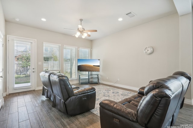 living room with dark wood-type flooring and ceiling fan