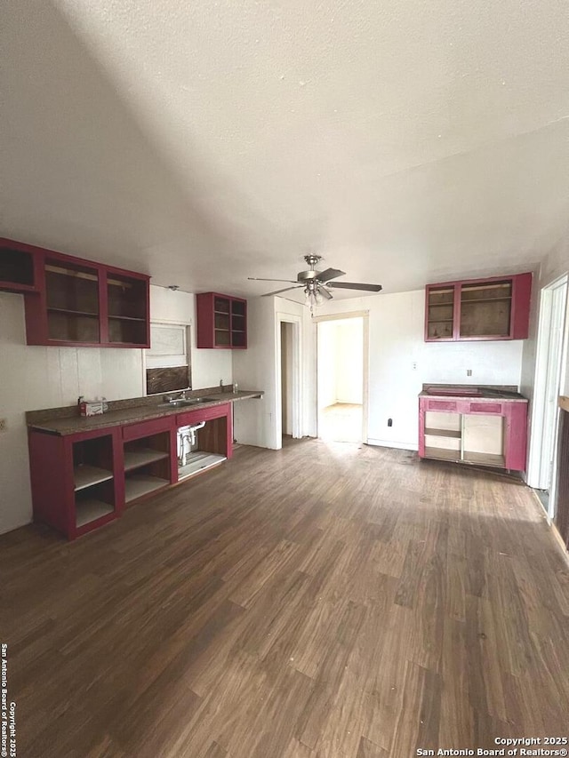 kitchen featuring ceiling fan, dark hardwood / wood-style flooring, and a textured ceiling