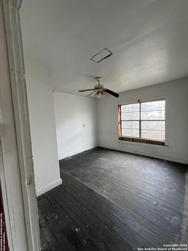 empty room featuring dark hardwood / wood-style flooring and ceiling fan