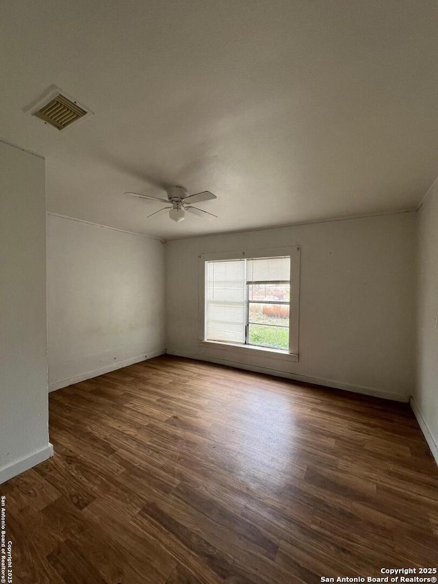 unfurnished room featuring ceiling fan and dark wood-type flooring