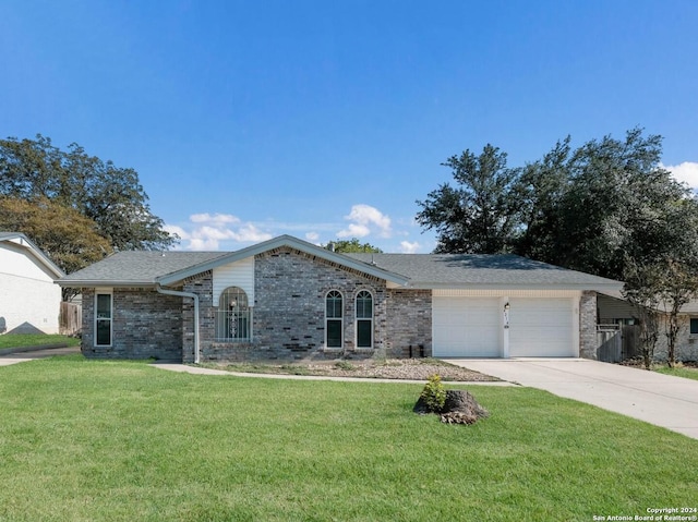 single story home with a garage and a front yard