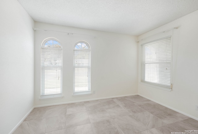 spare room featuring a textured ceiling