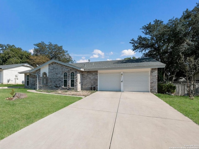 single story home featuring a front lawn and a garage