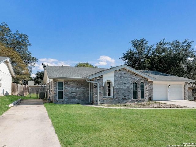 single story home featuring a garage, cooling unit, and a front lawn