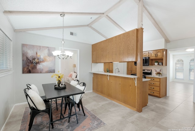 kitchen with an inviting chandelier, decorative light fixtures, stainless steel appliances, kitchen peninsula, and vaulted ceiling with beams