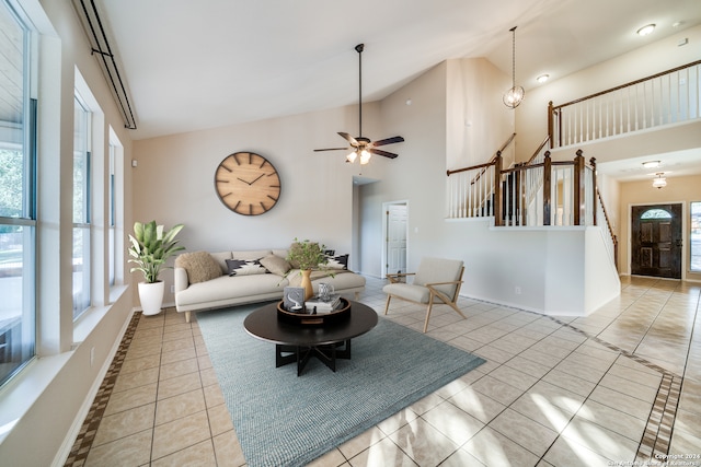 living room with high vaulted ceiling, ceiling fan, and light tile patterned floors