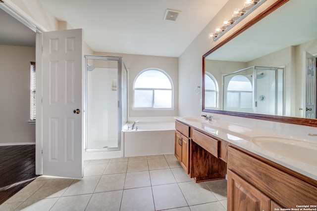 bathroom featuring independent shower and bath, vanity, and tile patterned flooring