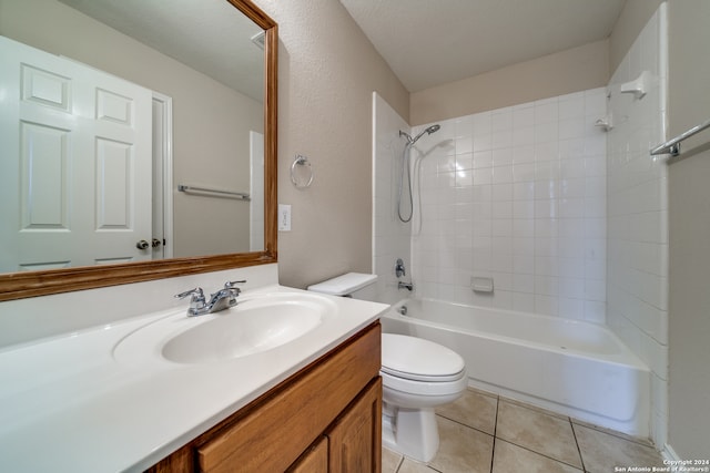 full bathroom with vanity, tiled shower / bath, tile patterned flooring, toilet, and a textured ceiling