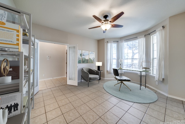 interior space with light tile patterned floors and ceiling fan