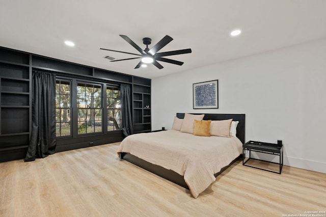 bedroom with ceiling fan and light hardwood / wood-style floors