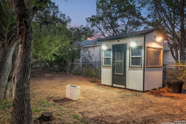 view of outdoor structure at dusk